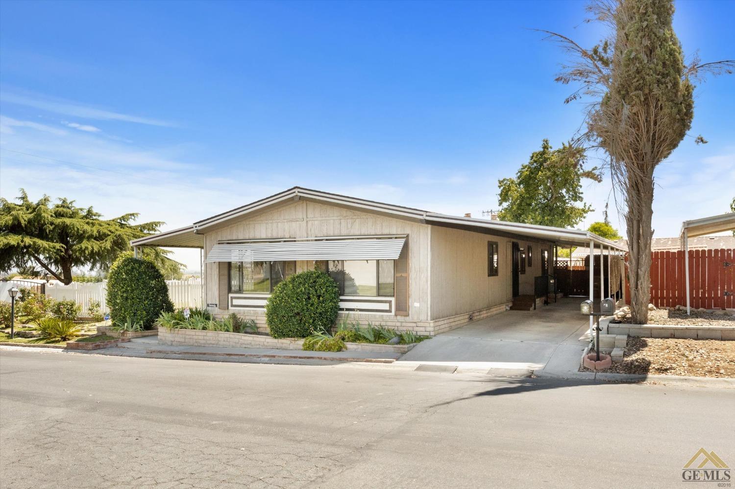 Undisclosed Address Bakersfield, CA 93306 - Photo 3 of 32 a front view of a house with a yard