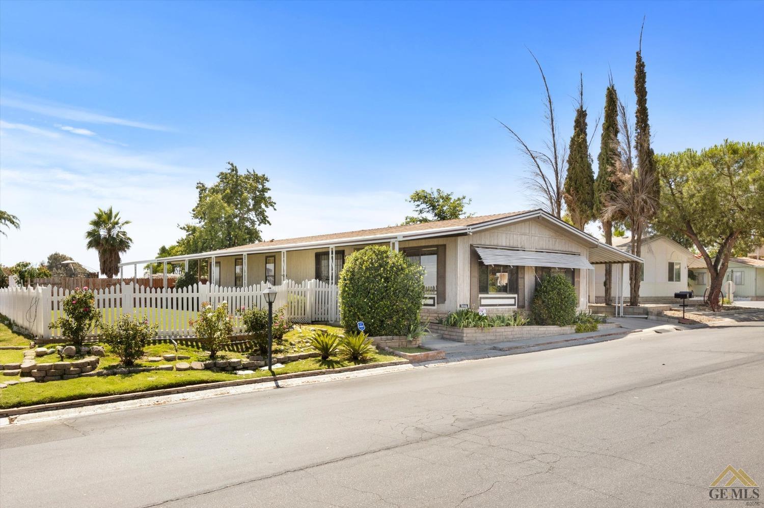 Undisclosed Address Bakersfield, CA 93306 - Photo 4 of 32 a front view of a house with a yard