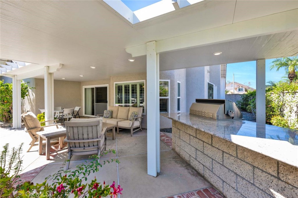 7710 East Strawberry Ridge Orange, CA 92869 - Photo 5 of 33 The rear patio features a built-in BBQ island and solid cover with lighting.