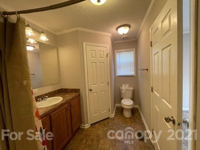 284 Pearidge Road Bostic, NC 28018 - Photo 13 of 29 a bathroom with a granite countertop sink a toilet a mirror and shower