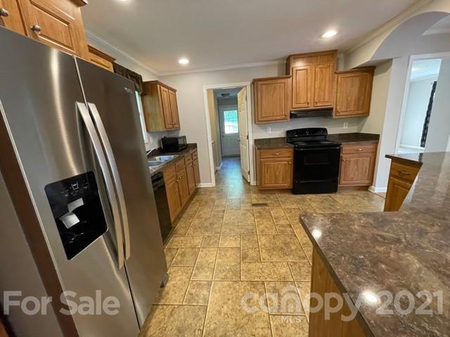 284 Pearidge Road Bostic, NC 28018 - Photo 20 of 29 a kitchen with stainless steel appliances granite countertop a refrigerator stove and sink