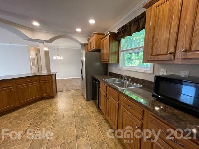 284 Pearidge Road Bostic, NC 28018 - Photo 21 of 29 a large kitchen with stainless steel appliances granite countertop a sink and a stove