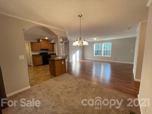 284 Pearidge Road Bostic, NC 28018 - Photo 6 of 29 a view of a room with wooden floor and a kitchen