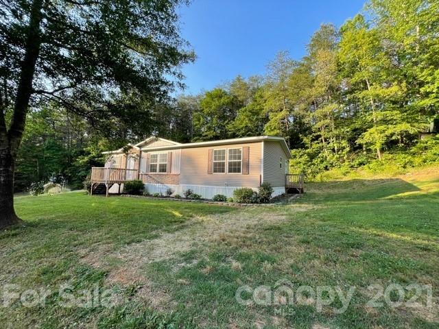 284 Pearidge Road Bostic, NC 28018 - Photo 8 of 29 a view of a backyard with plants and large trees