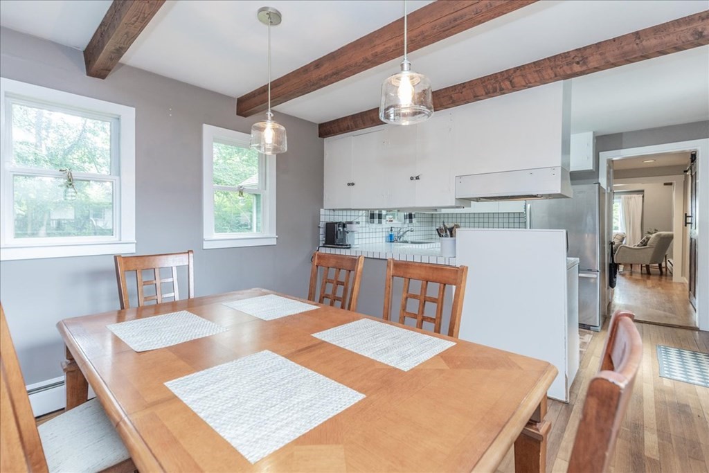 14 Francis Wyman Road Burlington, MA 01803 - Photo 17 of 39 a open kitchen with stainless steel appliances granite countertop a stove a refrigerator a dining table and chairs with wooden floor