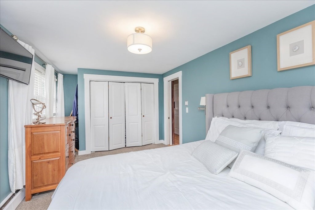 14 Francis Wyman Road Burlington, MA 01803 - Photo 20 of 39 a bedroom with a large bed and chandelier