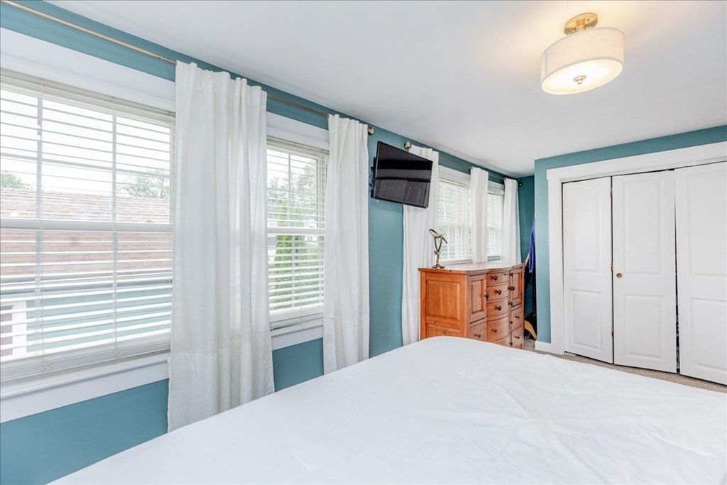 14 Francis Wyman Road Burlington, MA 01803 - Photo 21 of 39 a bedroom with a large bed and chandelier