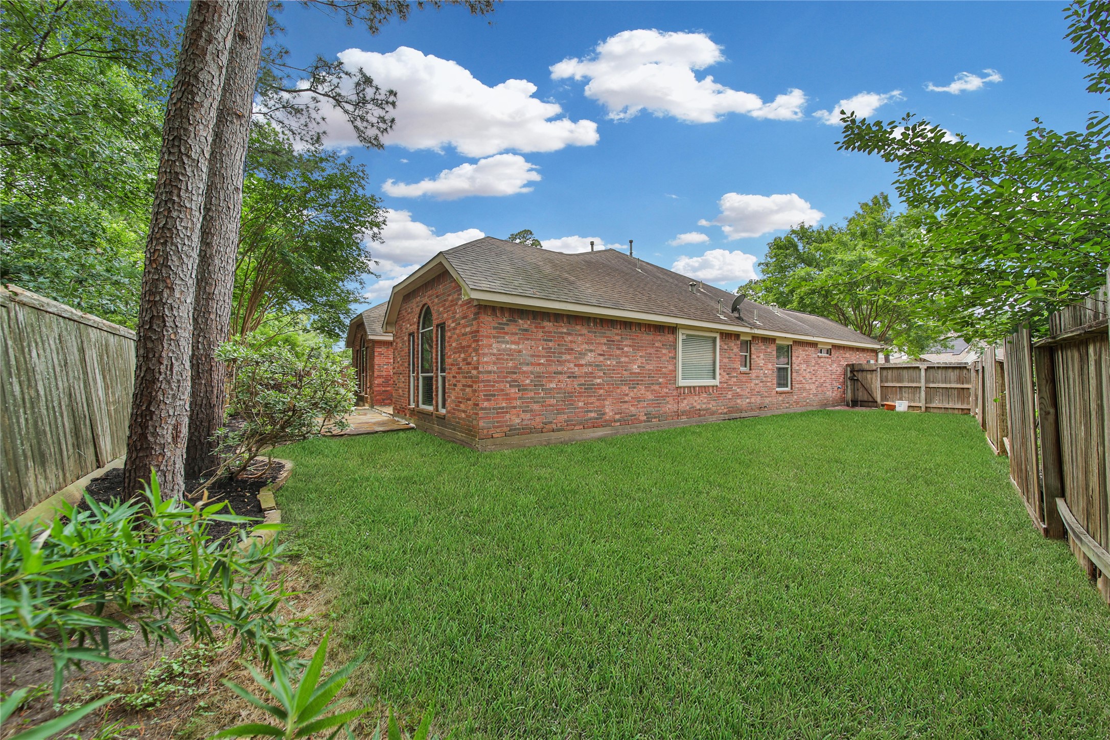 14526 Red Tailed Hawk Lane Houston, TX 77044 - Photo 34 of 40 a front view of a house with garden
