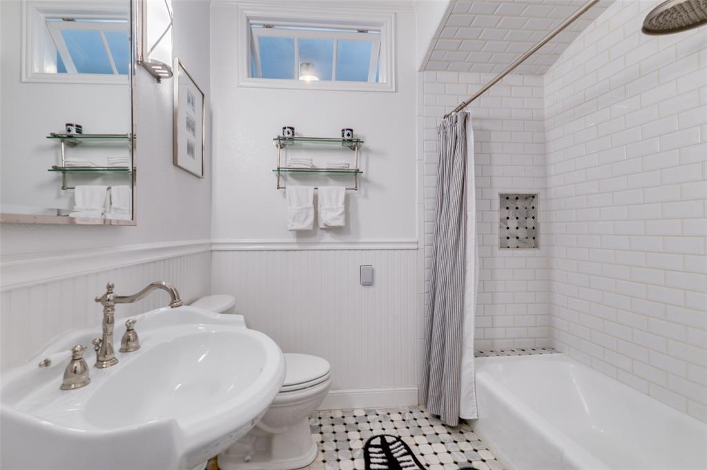 5407 Merrimac Avenue Dallas, TX 75206 - Photo 15 of 26 a bathroom with a sink a toilet and shower