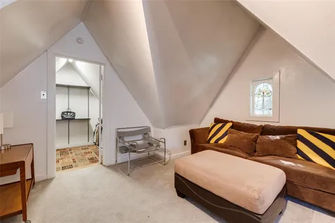 a bedroom with furniture and a potted plant