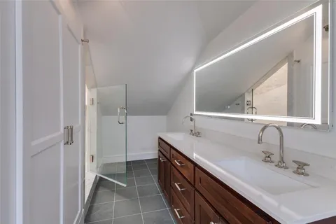a bathroom with a double vanity sink and mirror
