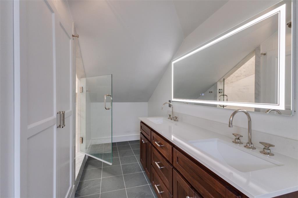 5407 Merrimac Avenue Dallas, TX 75206 - Photo 19 of 26 a bathroom with a double vanity sink and mirror
