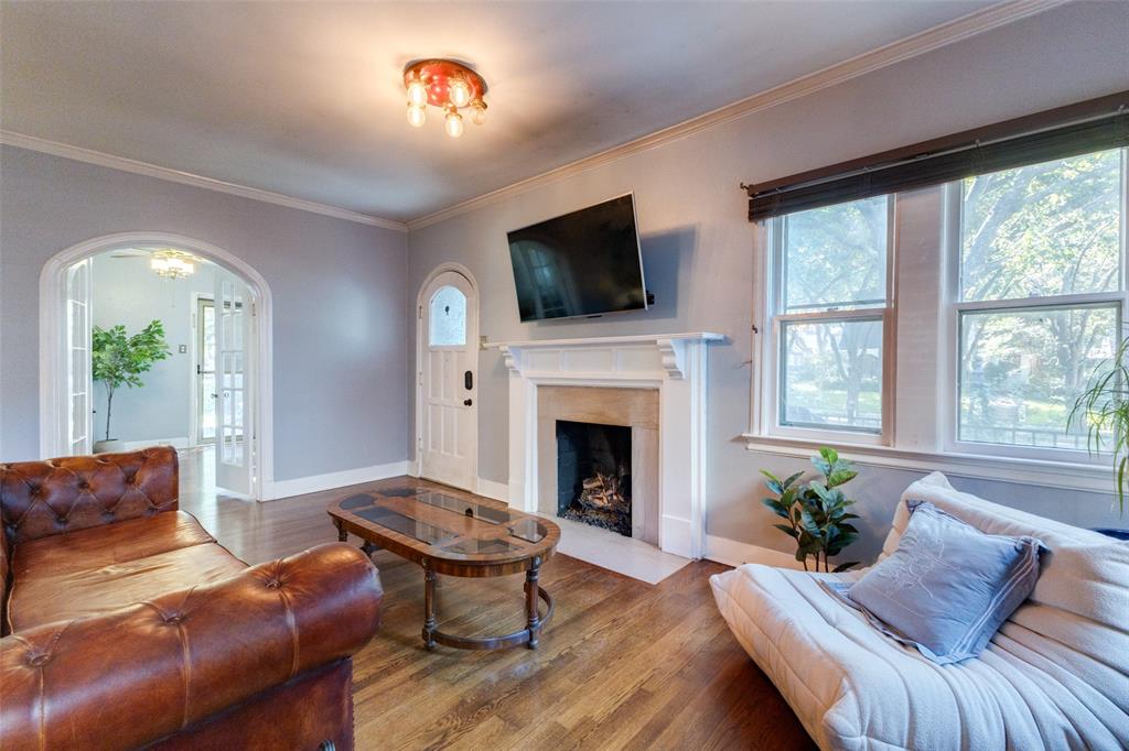 5407 Merrimac Avenue Dallas, TX 75206 - Photo 2 of 26 a living room with furniture fireplace and a flat screen tv
