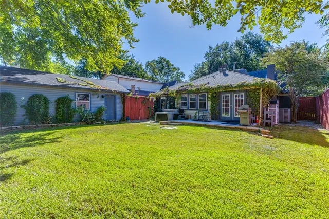 a view of a house with swimming pool and a yard