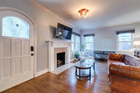 a living room with furniture fireplace and flat screen tv