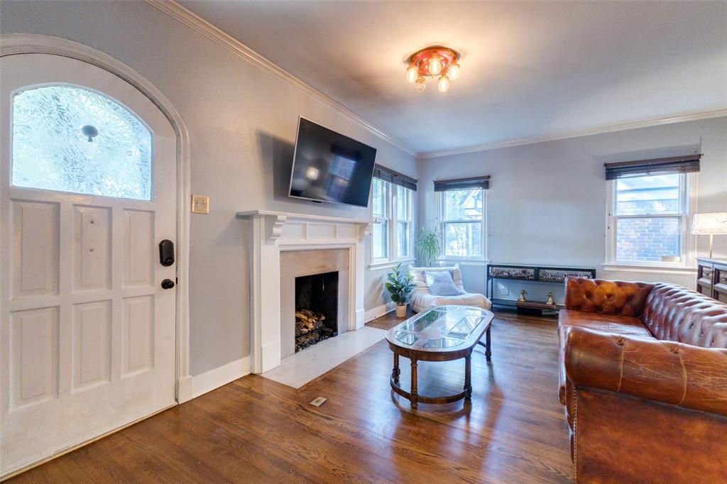 5407 Merrimac Avenue Dallas, TX 75206 - Photo 3 of 26 a living room with furniture fireplace and flat screen tv