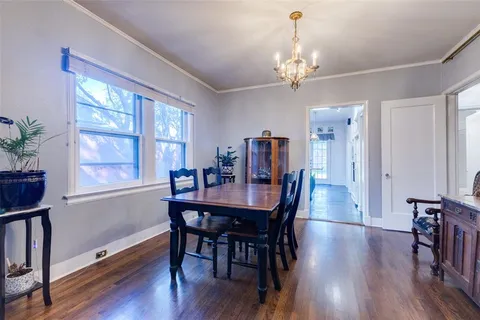 a view of a a dining room with furniture window and wooden floor
