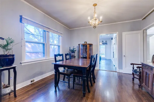 a view of a a dining room with furniture window and wooden floor