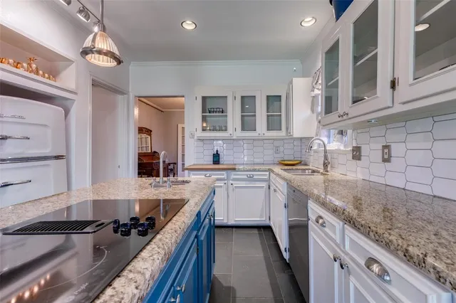 a kitchen with a sink stove and cabinets