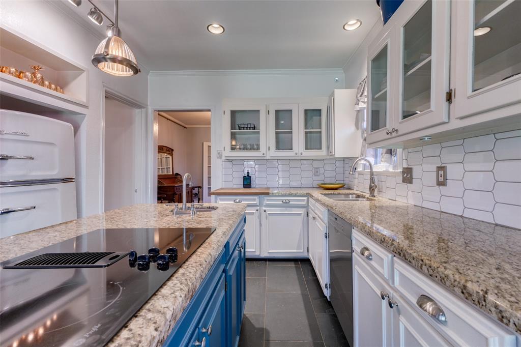 5407 Merrimac Avenue Dallas, TX 75206 - Photo 9 of 26 a kitchen with a sink stove and cabinets