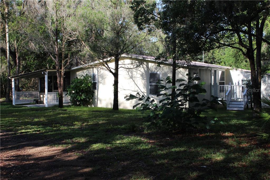 3055 Walk In Water Road Lake Wales, FL 33898 - Photo 1 of 1 Home Sweet Home 3/2 with Den, Large Barn/Work Shop, Pond, RV Port on 2+ Fenced and Wooded Acres.