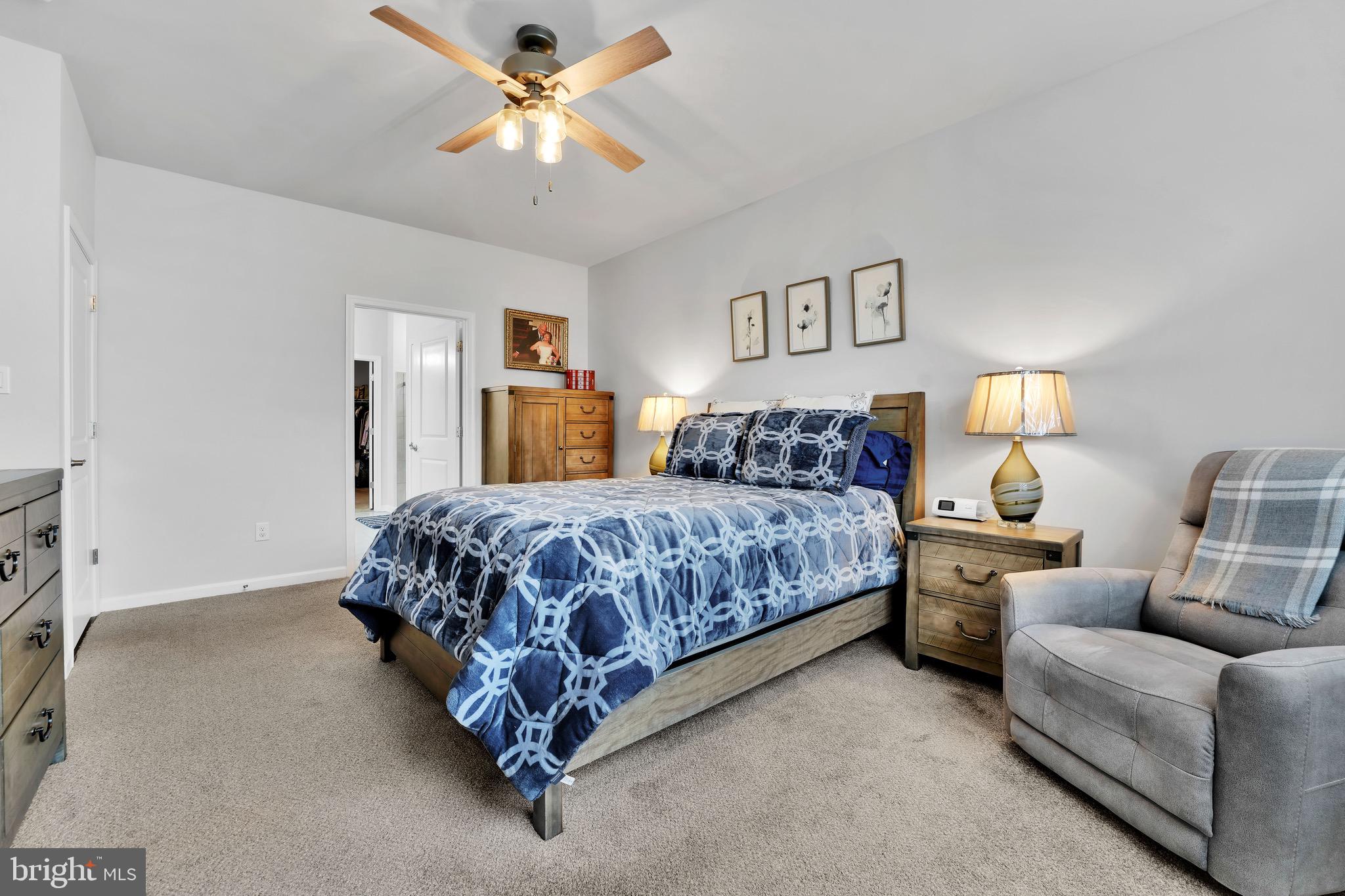 127 Raccoon Lane Barnegat, NJ 08005 - Photo 13 of 19 a bedroom with a bed couch chandelier and a window