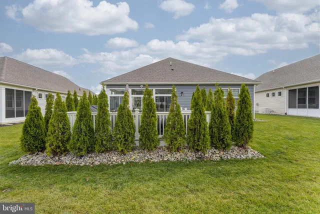 a front view of house with a garden