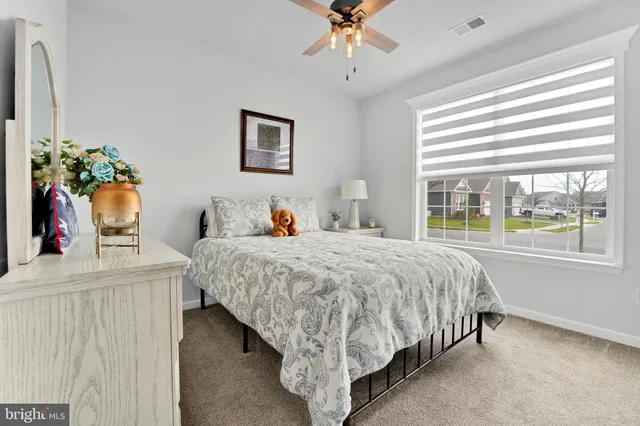 a bed sitting in a bedroom next to a window