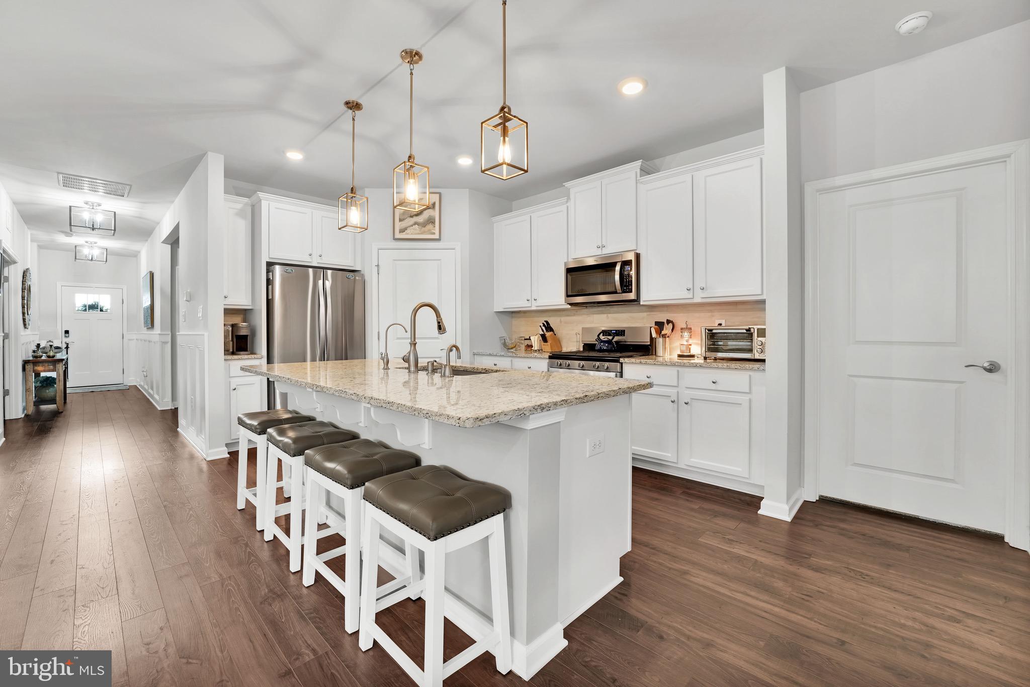 127 Raccoon Lane Barnegat, NJ 08005 - Photo 7 of 19 a kitchen with stainless steel appliances a stove a sink a refrigerator and a wooden floor