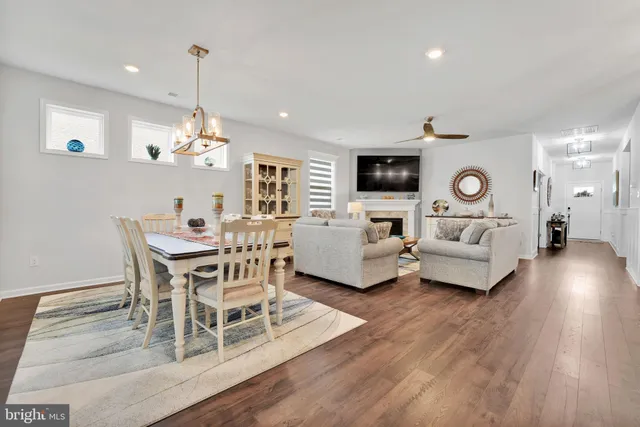 a view of a dining room with furniture wooden floor and chandelier