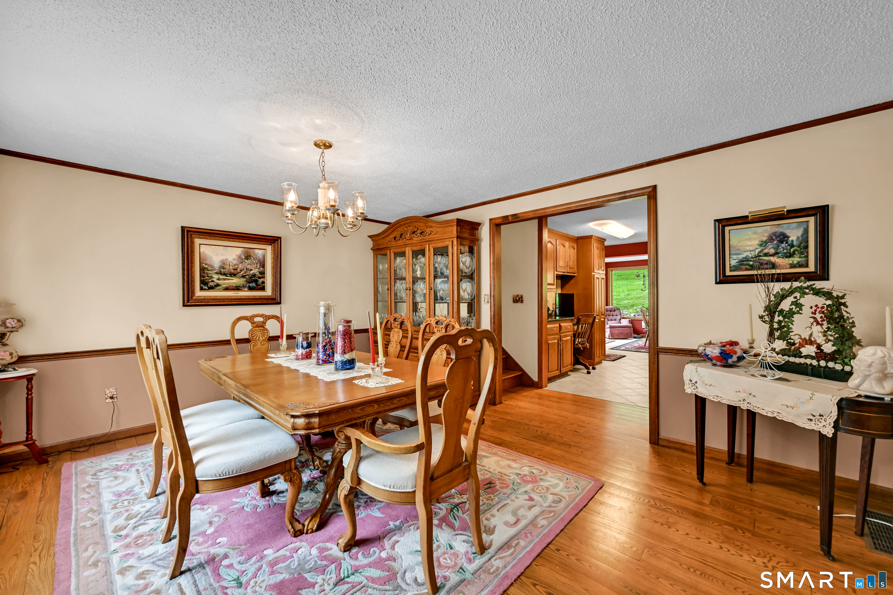 155 Lake Harwinton Road Harwinton, CT 06791 - Photo 11 of 39 a dining room with furniture a chandelier and wooden floor