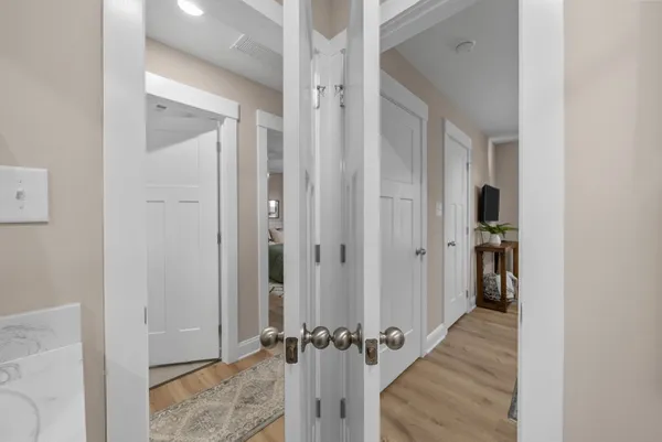 a view of a hallway with wooden floor and staircase
