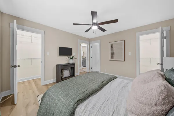 a bedroom with a large bed and a flat screen tv