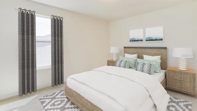 a bedroom with a large bed and a window