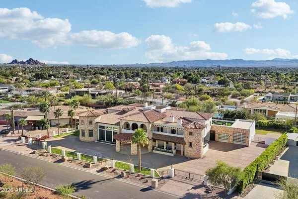 a front view of a house with swimming pool having outdoor seating