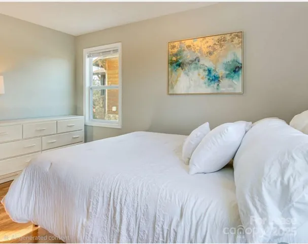 a bedroom with a bed and a painting on the wall