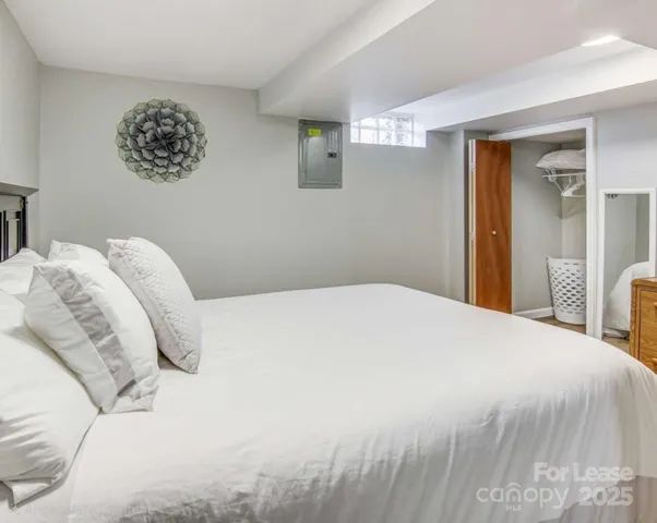 a bedroom with a bed and a chair