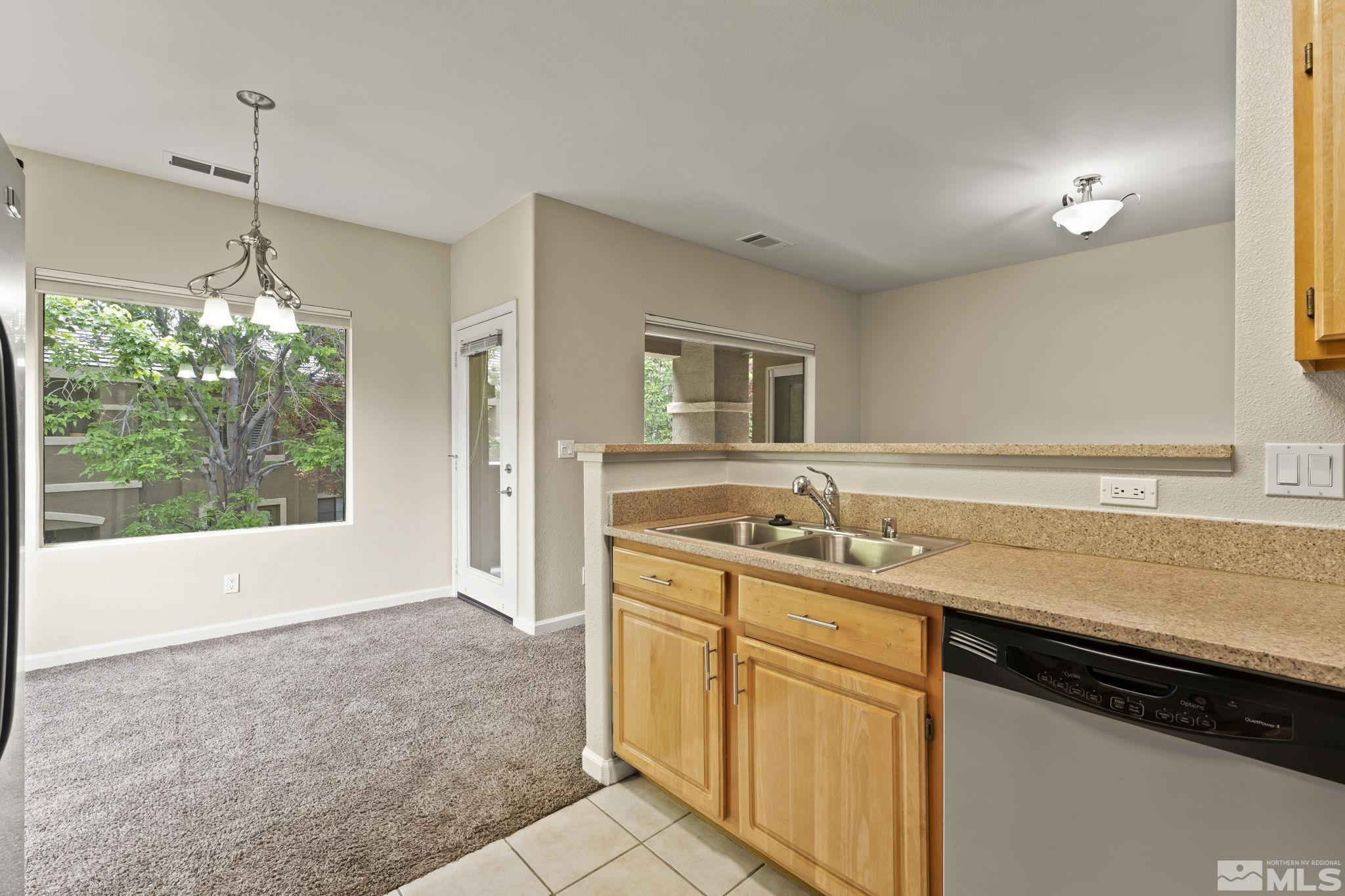 900 South Meadows Parkway, Unit 321 Reno, NV 89521 - Photo 1 of 40 a kitchen with a sink stove and cabinets