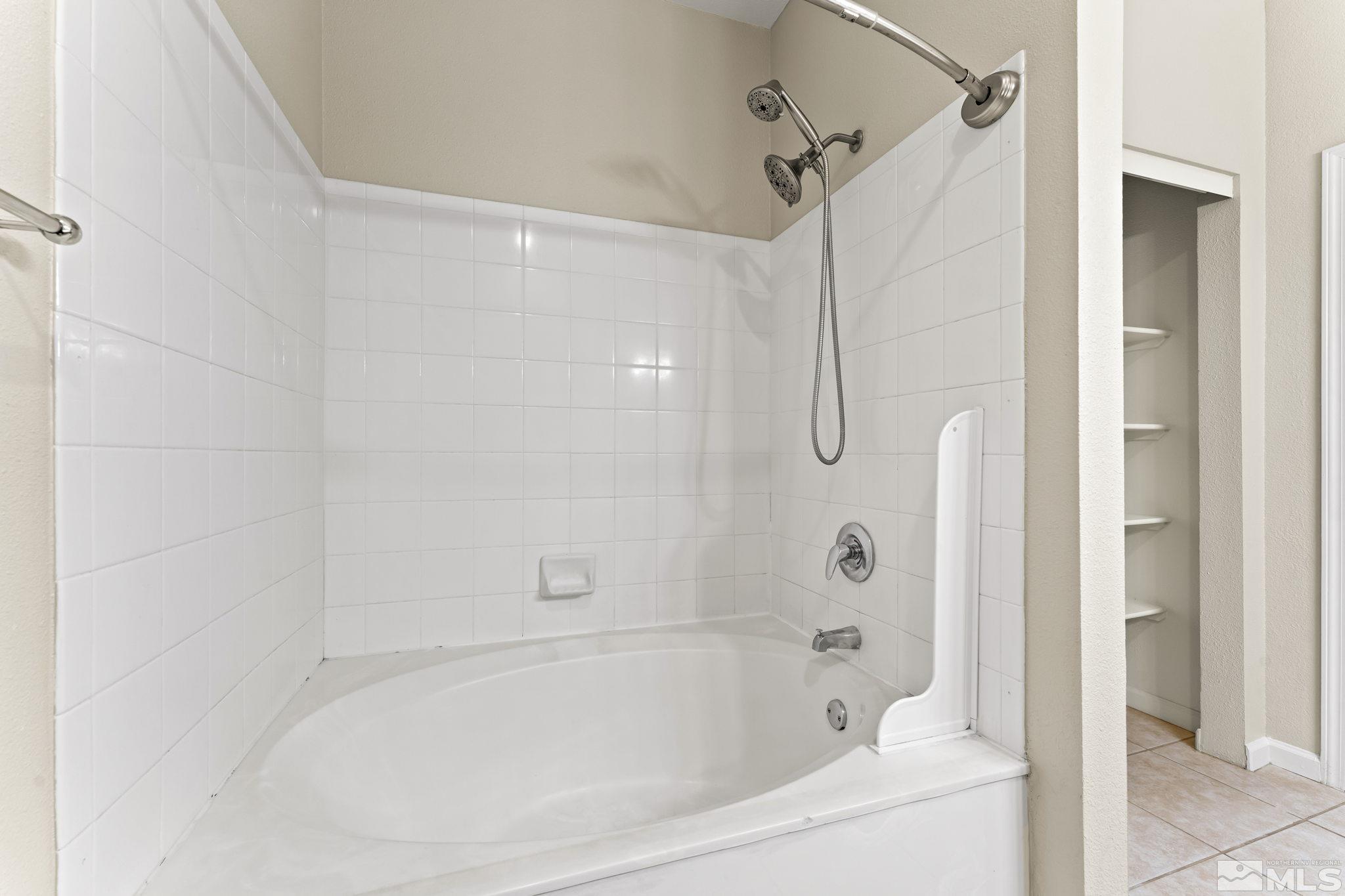 900 South Meadows Parkway, Unit 321 Reno, NV 89521 - Photo 12 of 40 a bathroom with a shower and a bath tub