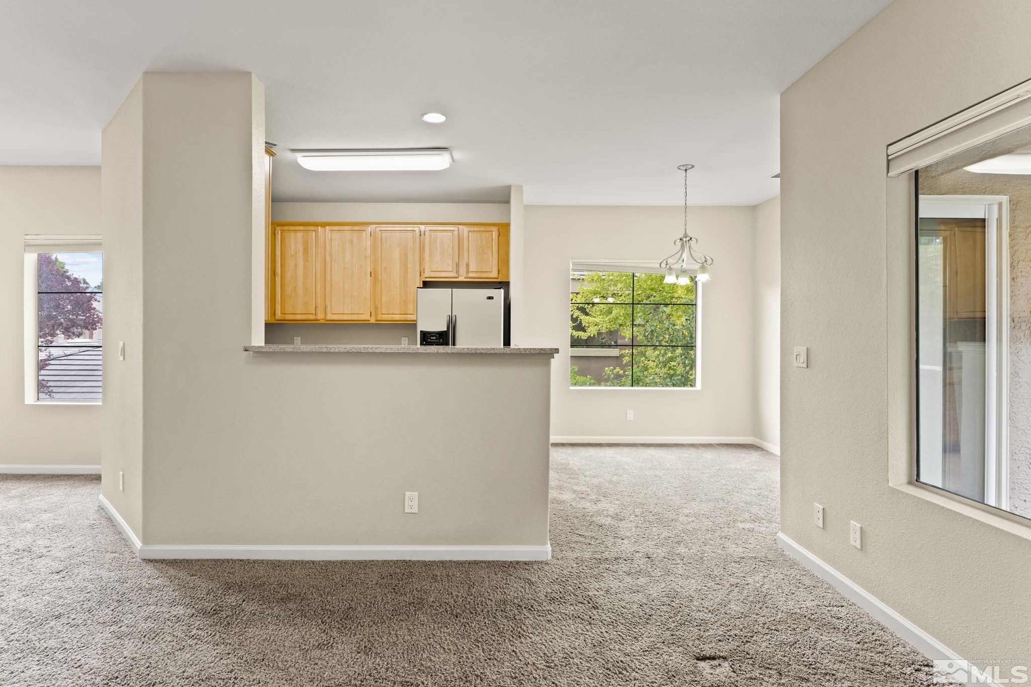 900 South Meadows Parkway, Unit 321 Reno, NV 89521 - Photo 22 of 40 an empty room with windows and closet