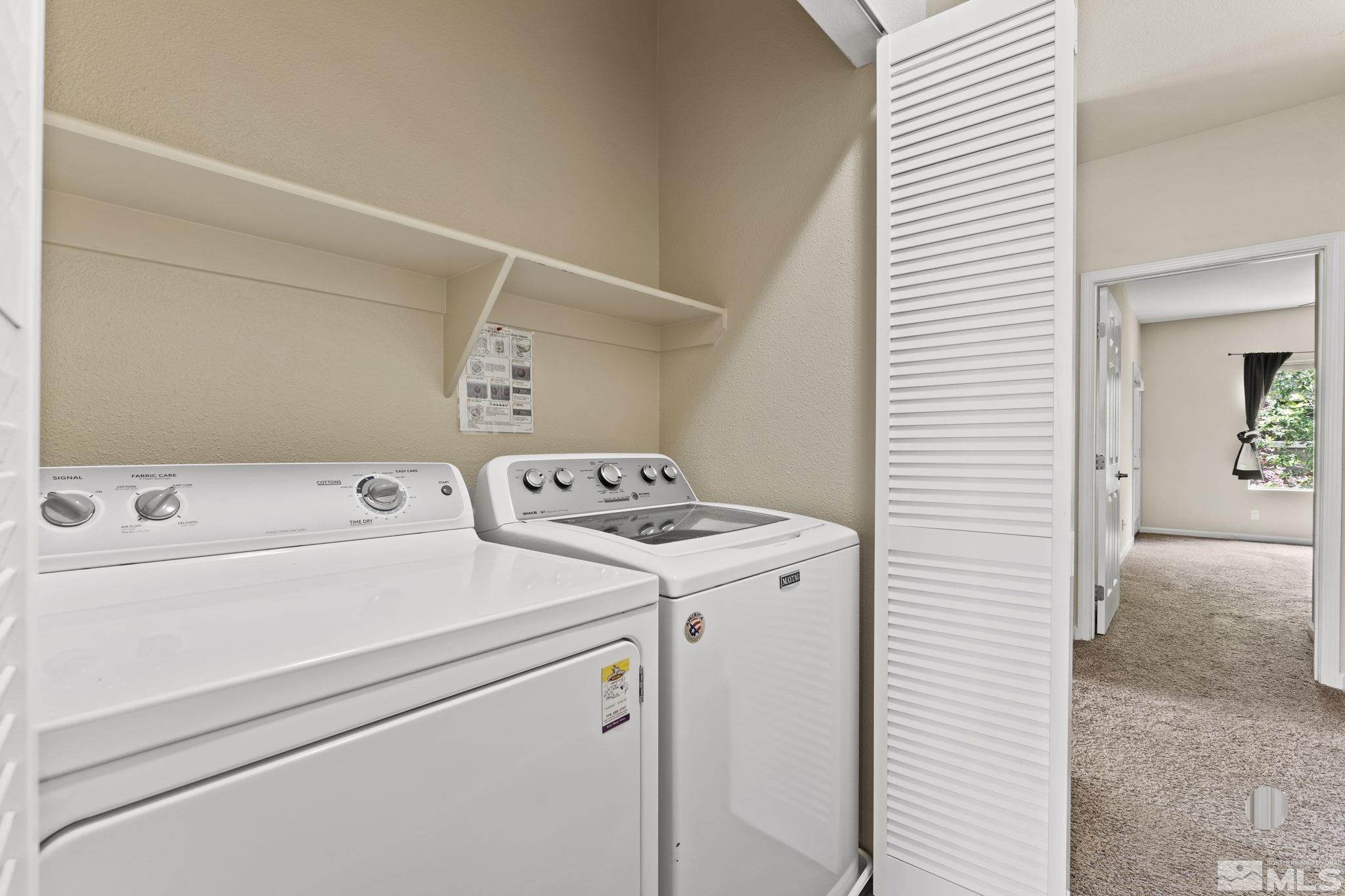 900 South Meadows Parkway, Unit 321 Reno, NV 89521 - Photo 24 of 40 a view of washer and dryer with kitchen in the background