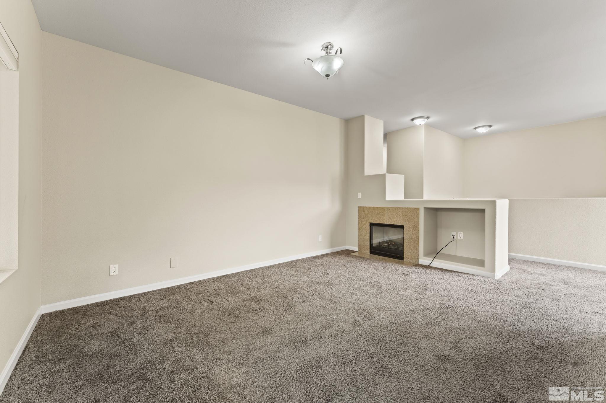 900 South Meadows Parkway, Unit 321 Reno, NV 89521 - Photo 25 of 40 an empty room with a fireplace