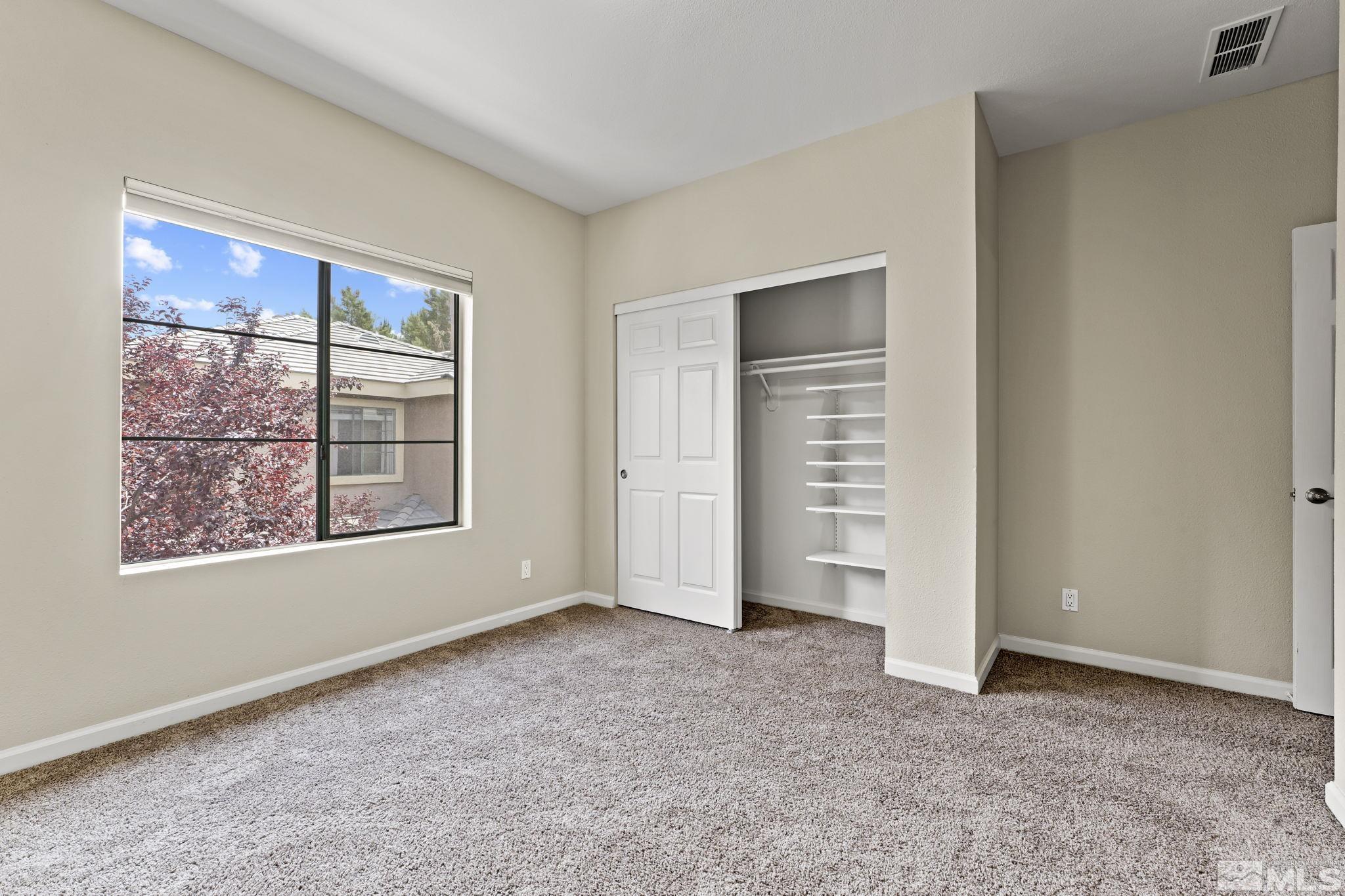 900 South Meadows Parkway, Unit 321 Reno, NV 89521 - Photo 7 of 40 an empty room with windows and closet