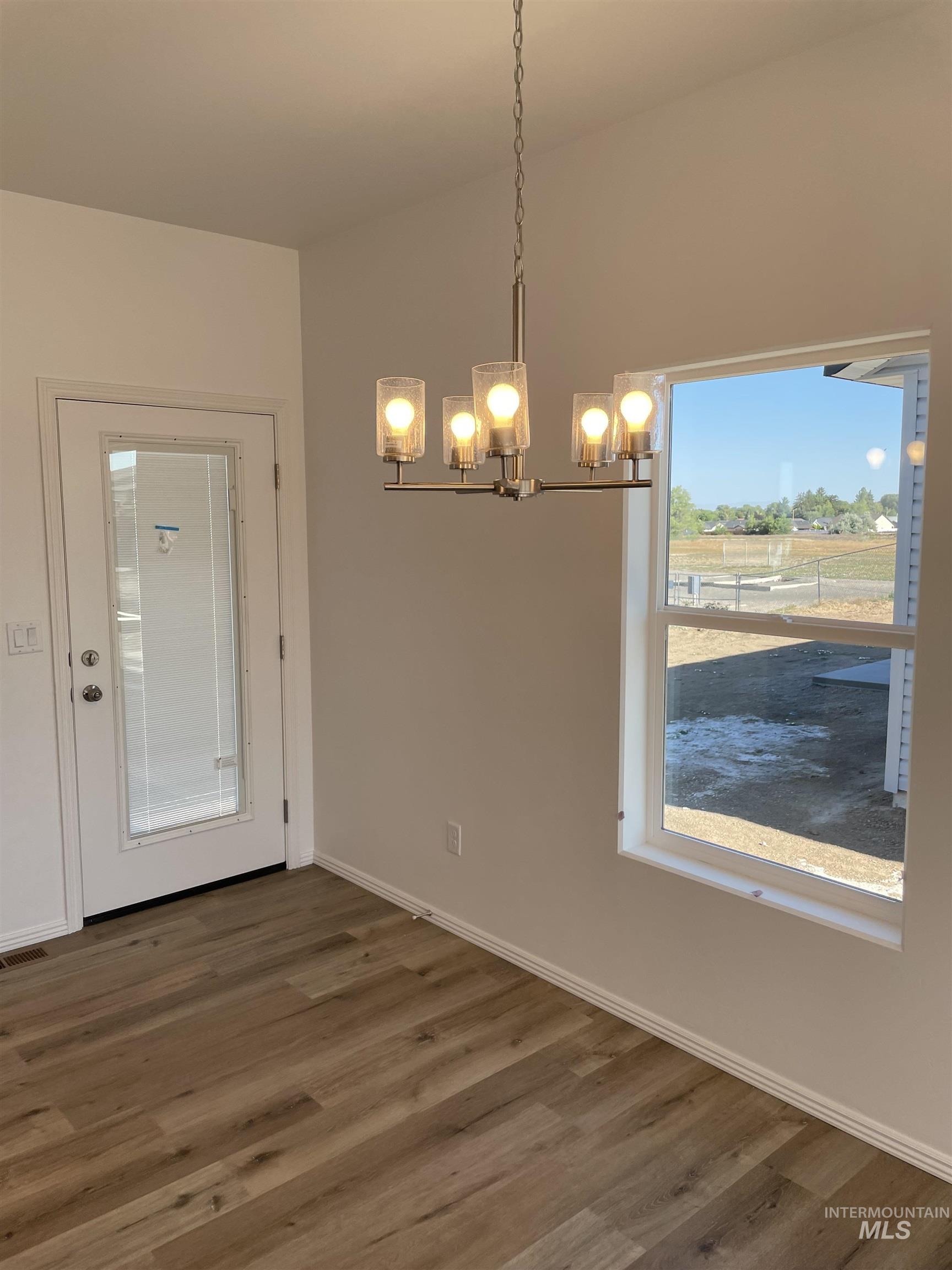1333 Luther Road Jerome, ID 83338 - Photo 4 of 9 Room with light-colored carpeting, two windows, and a white paneled door