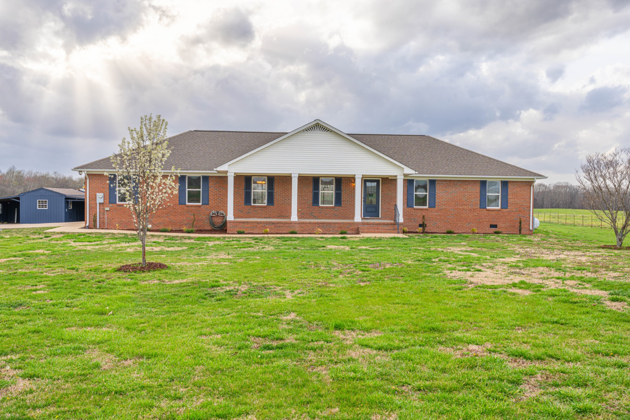 a front view of a house with a garden