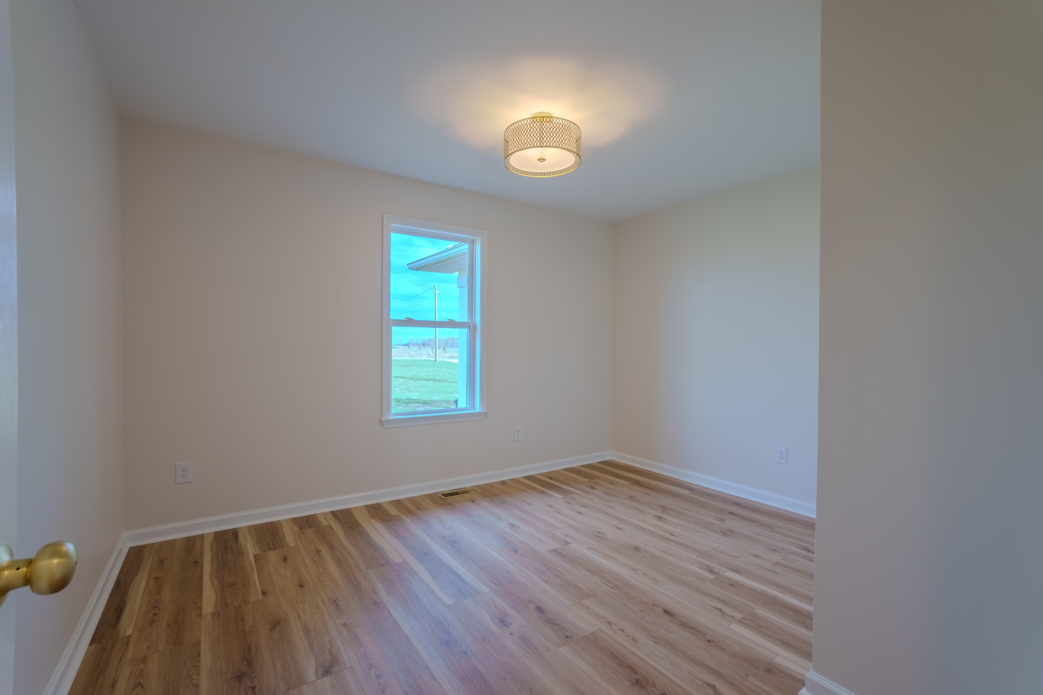 105 Peppertown Road Loretto, TN 38469 - Photo 18 of 37 a view of an empty room with wooden floor and a window