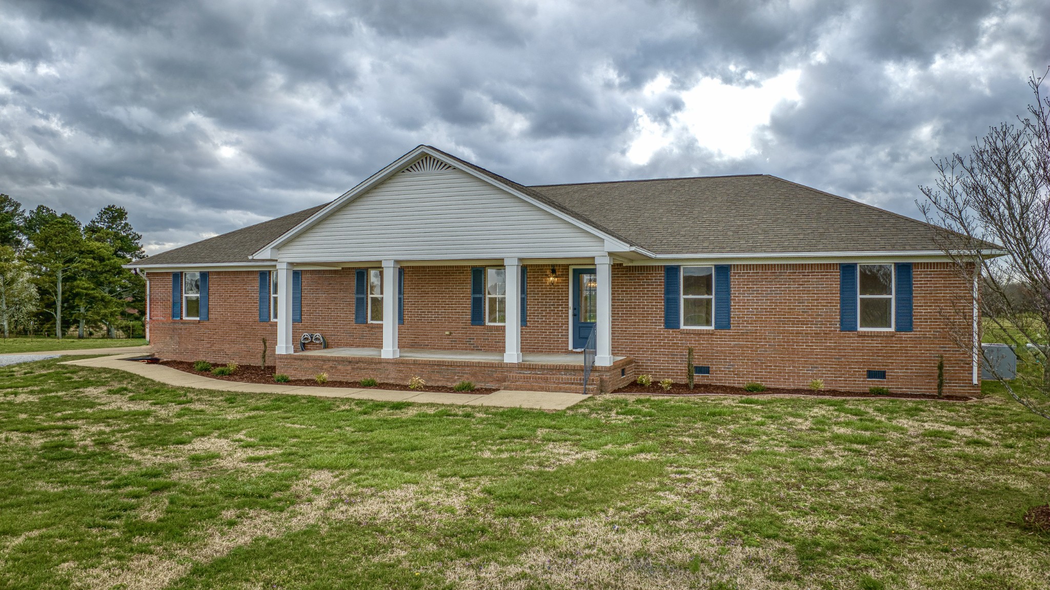 105 Peppertown Road Loretto, TN 38469 - Photo 2 of 37 a front view of a house with a garden and yard