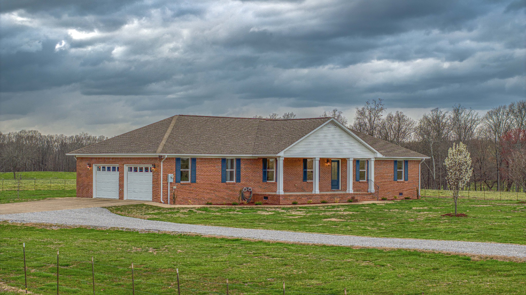105 Peppertown Road Loretto, TN 38469 - Photo 3 of 37 a view of a house with a big yard and large trees