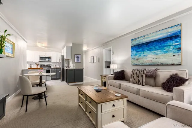a living room with furniture and kitchen view