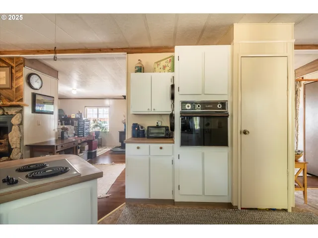 a kitchen with granite countertop white cabinets sink and window